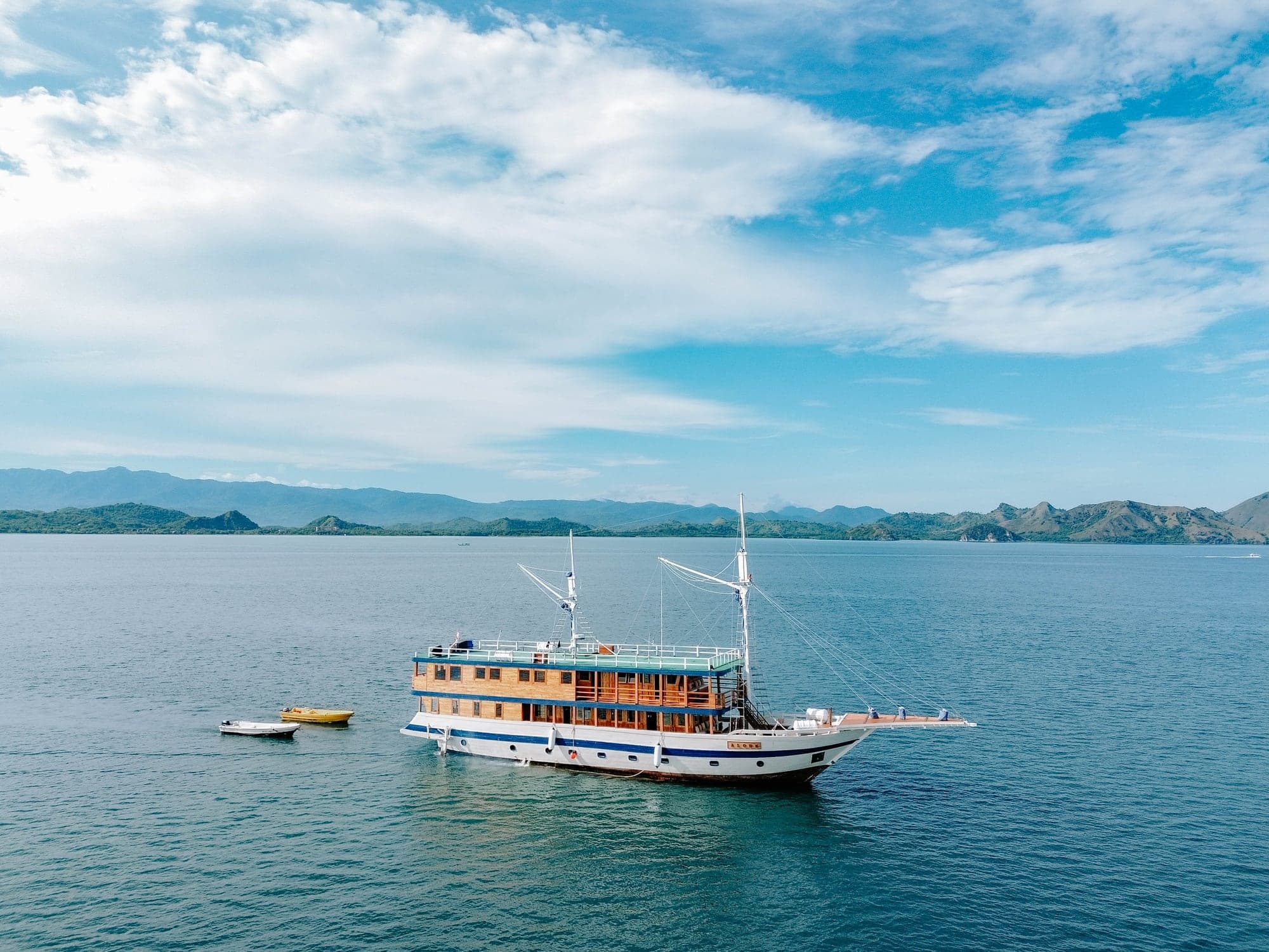 The phinisi schooner Alore seen whole, at anchor in Komodo